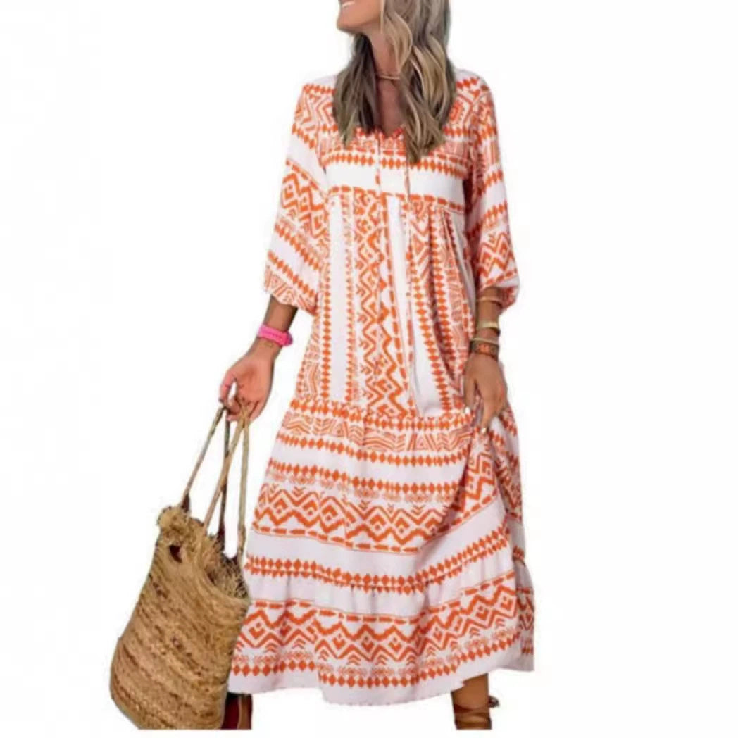 A woman in a summer bohemian v-neck dress stands by green doors, showcasing a flowy silhouette and boho-inspired design.