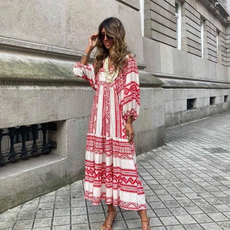 A woman in a summer bohemian v-neck dress stands by green doors, showcasing a flowy silhouette and boho-inspired design.